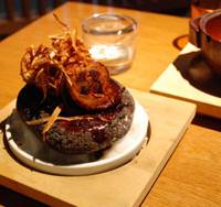 Fowl flavors: Grilled chicken and burdock root on a hot stone. Yasaiya Mei