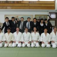 It was a riot: Carter and classmates pose for a shot with the riot police who joined them on the 11-month Senshusei Aikido course at the Yoshinkan Honbu Dojo. Battered Briton survives aikido ordeal
