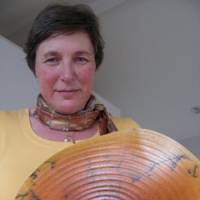 Swanica Ligtenberg holds a plate titled “Circles of Life” at her studio in Kamakura, Kanagawa Prefecture. Below is one of her ceramic works ? a tea bowl featuring wave patterns. An artist's love affair with ceramics