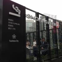 Smokers\' style:  Toshima Ward\'s emblem adorns the new smoking area in front of the East Exit of Ikebukuro Station in  Tokyo. | AKINORI KURUMA