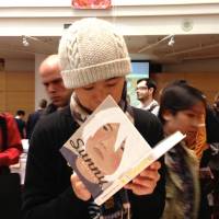 Taiyo Matstumoto signs a copy of his \"Sunny\" at the Toronto Comic Arts Festival . | ANNE ISHII