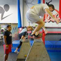 The rail thing: Participants in an Urban Evolutions parkour class climb and jump over obstacles. | THE WASHINGTON POST
