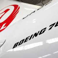 Hung up: Japan Airlines Co.\'s first Boeing Co. 787 Dreamliner aircraft sits in a hangar during a media preview at Narita airport in March 2012. | BLOOMBERG