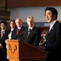 Full speed ahead: Prime Minister Shinzo Abe speaks at the Titanic Museum in Belfast, Northern Ireland, on Tuesday. Pitch to G-8 colleagues leaves Abe in a bind