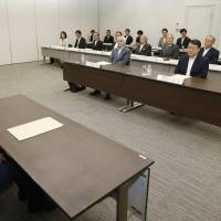 One\'s a crowd: A Finance Ministry official attends a Thursday general shareholders\' meeting of Japan Post Holdings Co. in Tokyo\'s Kasumigaseki district. | KYODO