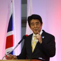 Pouring it on: Prime Minister Shinzo Abe gives a speech at the Guildhall in London on Wednesday. Abe's rhetoric reveals a growth strategy aimed at global conquest