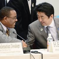 Safe and sound: Prime Minister Shinzo Abe greets Ethiopian Prime Minister Hailemariam Desalegn at a symposium on human security Sunday in Yokohama on the sidelines of the Tokyo International Conference on African Development. | AP