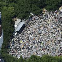 Opposition continues: Thousands of opponents of nuclear power gather near Tokyo Tower in Minato Ward to stage a march Sunday toward the Diet. | KYODO