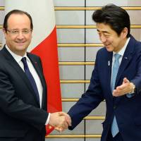 Fraternity: French President Francois Hollande is welcomed by Prime Minister Shinzo Abe before their Friday meeting in Tokyo. | AFP-JIJI