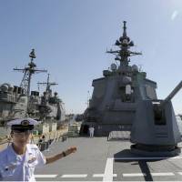 Ship-shape: A Maritime Self-Defense Force official shows off the Aegis-equipped destroyer Atago to the press at U.S. Naval Base San Diego on Monday. The ship is participating in a bilateral drill in California to practice the retaking of remote islands. | KYODO