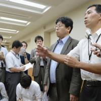 Official OK: Health Ministry officials answer questions from reporters Wednesday in Tokyo after the ministry\'s panel gave the green light to kick off clinical research using iPS cells for retinal regeneration. | KYODO
