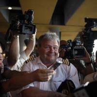 Welcome to Cuba: Journalists surround an Aeroflot flight crew member at Havana’s Jose Marti International Airport on Monday. Confusion over the whereabouts of Edward Snowden grew after flight SU150 flew from Moscow to Cuba with an empty seat booked in the former NSA contractor’s name. U.S. probes if China played role in Snowden leaks; fugitive not on Cuba flight