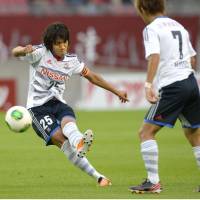 Lead by example: Yokohama F. Marinos captain Shunsuke Nakamura opens the scoring during his side\'s 2-0 win over Kashima Antlers in their Nabisco Cup quarterfinal first leg on Sunday. | KYODO