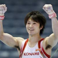 Kohei Uchimura, the first five-time consecutive men\'s champion of the NHK Cup, gestures to the crowd Sunday. | KYODO