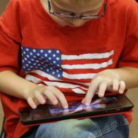 Finger-pointing: A second-grader uses an Apple iPad at Park Lane Elementary School in Sandy, Utah. | BLOOMBERG