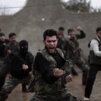 Syrian rebels attend a training session in Maaret Ikhwan, near Idlib, last December. | AP