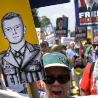Rallying the troops: Protesters march during a rally in support of U.S. Army Pfc. Bradley Manning outside of Fort Meade, Maryland, on Saturday. Manning, whose court-martial kicked off Monday, is accused of sending hundreds of thousands of classified records to whistle-blower website WikiLeaks while working as an intelligence analyst in Baghdad. Manning 'harvested' secret papers: prosecution