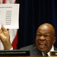 Case closed?: Rep. Elijah Cummings, ranking Democrat on the House Oversight and Government Reform Committee, holds up a sheet detailing IRS conference spending as he makes opening remarks on Capitol Hill in Washington on Thursday. Lawmaker traces origin of IRS row to Cincinnati