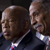Witnesses: Rep. John Lewis, a Democrat from Georgia (left), and Rep. John Conyers, Democrat from Michigan (right), the co-chairs of the Civil Rights Taskforce of the Congressional Black Caucus, express disappointment in the Supreme Court\'s decision on Shelby County v. Holder that invalidates Section 4 of the Voting Rights Act on Tuesday on Capitol Hill. Lewis, a prominent activist in the Civil Rights Movement, recalled being attacked and beaten trying to help people in Mississippi register to vote in the 1960s. | AP