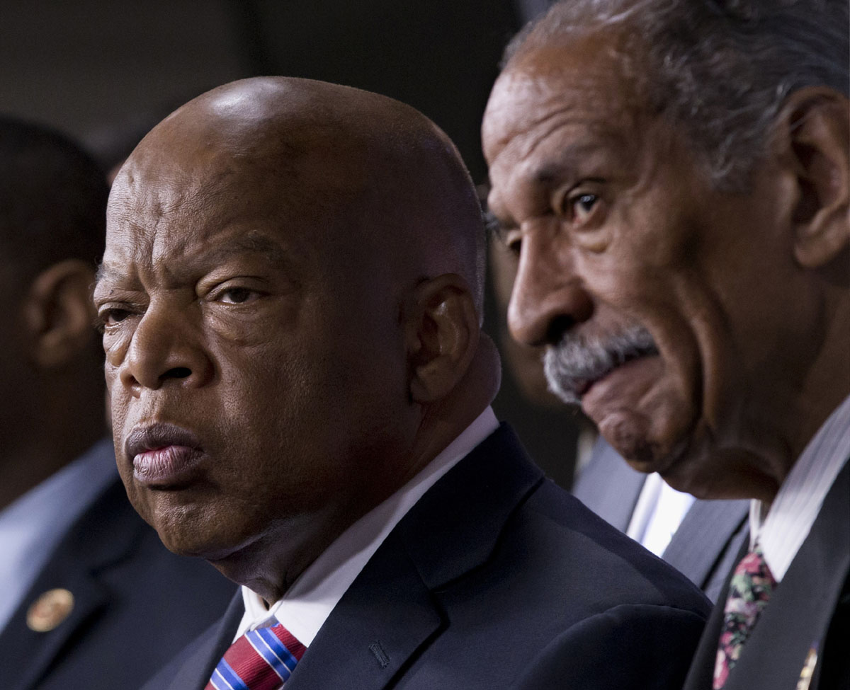 Witnesses: Rep. John Lewis, a Democrat from Georgia (left), and Rep. John Conyers, Democrat from Michigan (right), the co-chairs of the Civil Rights Taskforce of the Congressional Black Caucus, express disappointment in the Supreme Court's decision on Shelby County v. Holder that invalidates Section 4 of the Voting Rights Act on Tuesday on Capitol Hill. Lewis, a prominent activist in the Civil Rights Movement, recalled being attacked and beaten trying to help people in Mississippi register to vote in the 1960s. | AP