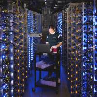 Heart of the matter: A Google technician diagnoses an overheated computer processor at the Internet giant\'s data center in The Dalles, Oregon. Google uses these data centers to store email, photos, video, calendar entries and other information shared by its users. These centers also process the hundreds of millions of searches that Internet users make on the website each day. | AP