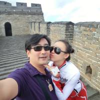 Travel for two: Fan Yue, deputy director of policy and regulation under the State Archives Administration, takes a photograph of himself and his mistress, Ji Yingnan, at the Great Wall of China. | THE WASHINGTON POST