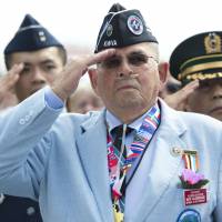 Remembering the fallen: Roy Aldridge of the Korean War Veterans Association salutes during a ceremony for the 60th anniversary of the signing of the armistice that ended the war. The event was held at the Korean War Veterans Memorial in Washington on Saturday. | AFP-JIJI