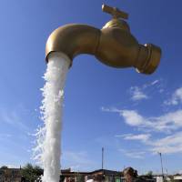Women splash about  Tuesday by a fountain outside Krasnoyarsk in Siberia. | REUTERS/KYODO