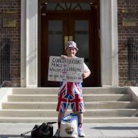 Well wisher: Royal supporter Terry Hutt poses for a photograph as he arrives at the Lindo Wing of St. Mary’s Hospital in London, where Kate, Duchess of Cambridge, is scheduled to deliver her baby — the future king or queen of England. Media barge into royal baby's life before it's born