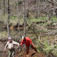 Hard labor: After removing by hand tons of mud from the pond (above), the next job was to embed posts round the sides and weave in branches (below). | C.W. NICOL PHOTOS