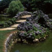 Shapely span: Chinese style and Okinawan exuberance combine in this charming humped bridge made of coral limestone. Like the rest of Shikina-en Garden, which was obliterated by bombing in World War II, this bridge was reconstructed using much of its original material. | SATOKO KAWASAKI PHOTO