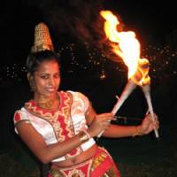 Warm welcome: Sri Lankan AUW student Ishara Piumi Warakagoda performs a traditional fire dance as a happy greeting to visitors to the campus. Although her parents\' business was burned down during ethnic violence, she has traveled in many parts of her homeland most affected by the civil war in a \"peace-through-art\" initiative, and aims to continue working toward ending the bloodshed that plagues Sri Lanka. | JEFF KINGSTON PHOTO