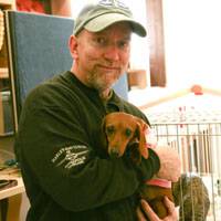 Scott Milburn is visibly tickled to be holding Playful, a darling of a dachshund. | KYOKO HARADA PHOTOS