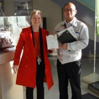 Fixing things up: Roschina presents yet another book of advice, \"Letters to Toyota,\" at the Hokkaido branch of Toyota. | COURTESY OF NATALIA ROSCHINA