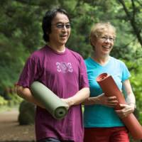 Kuzui and her husband, Kaz, stroll with their mats to their yoga studio. | COURTESY OF FRAN KUZUI