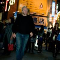 Night owl: Matt Naiman at a crossing in Tokyo\'s Shibuya, where he has run several bars and restaurants. (Below) Naiman gets hands-on at his Ruby Room bar. | TADAMASA IGUCHI PHOTOS
