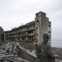 Coal comfort: A Buddhist statue on Hashima Island off Nagasaki &#8212; commonly known as Gunkanjima (Warship Island) &#8212; which was abandoned after its coal mine closed in 1974. | JUN NAKASUJI PHOTO
