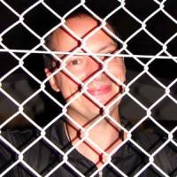 Your country\'s name\'s down, you\'re not coming in: Frenchman Eric Fior peers through the fence into the U.S. Navy Negishi Housing Base in Yokohama after being refused entry to the Negishi Open Base Bon Odori Festival last month. | BLAIR MCBRIDE PHOTO