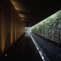 Grand entrance: Kengo Kuma combined bamboo clad-walls, stone paving, a bamboo hedge and the building\'s deep eaves to create this walkway at the entrance of the Nezu Museum, which opened last year in Tokyo. | &#169; MITSUMASA FUJITSUKA