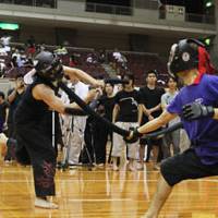 Battle ready: Two children compete in datotsu kyogi (hitting games). Below: Practitioners fight during a game. | JAPAN SPORTS CHANBARA ASSOCIATION