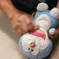 A doubtless doted-on Doraemon in need of repair. | EDAN CORKILL PHOTO