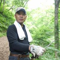 Point man: Bear-hunter Takashi Yoshikawa leads the way on our trek in the mountains. | TOMOKO OTAKE PHOTO