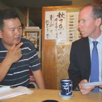 Shared loss: Sung-won Kang and Charles Lacey  meet in a Tokyo restaurant in 2011 to discuss their concerns over the police investigations into the deaths of their loved ones. | SIMON SCOTT