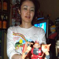 Flashy and fascinating: Ayako Otsuka, owner of a tiny Gundam-themed bar in Shinjuku\'s Golden Gai (above). Below: Gundam from behind | JUDIT KAWAGUCHI PHOTO
