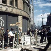 Look at the past: A 1945 photo by by Gaetano Faillace shows the building of Hattori Tokei-ten (K. Hattori &amp; Co. &#8212; the predecessor of Seiko Holding Corp.), requisitioned for use as a U.S. military commissary, at the Ginza 4-chome intersection. | GREG SAILOR