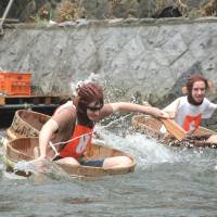 Rub-a-dub: Participants in a past International Tarai-nori Kyoso race paddle washtubs down the Matsukawa River in Ito, Shizuoka Prefecture. | ITO TOURISM ASSOCIATION