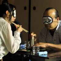 No peeking: Blindfolded diners at \"Journey in the Dark\" enjoy local dishes from Minami-Satsuma in Kagoshima Prefecture. | YOSHIAKI MIURA PHOTO