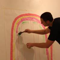 Isaac paints as he sings a rainbow song. | DANIELLE DEMETRIOU