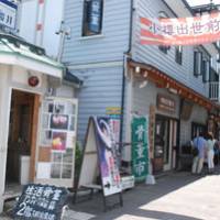 Getting around: Tourists explore an old street in central Otaru. | ANDREW KERSHAW PHOTO