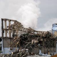 Four-decade \"accident\": The remains of the No. 3 reactor building smolder at the Fukushima No. 1 power plant in the town of Okuma, Fukushima Prefecture, on March 15, 2011, after a hydrogen explosion blew it apart. | TOKYO ELECTRIC POWER CO./AFP-JIJI